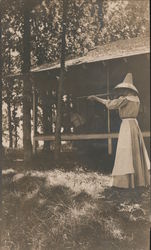 Woman Shooting Rifle outside Cabin Women Postcard Postcard Postcard