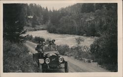 Four men in an early model automobile on a riverbank Cars Postcard Postcard Postcard