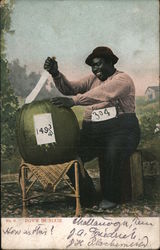 A Black Man Cutting a Fruit - Down In Dixie Postcard