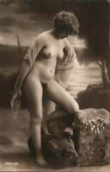 Woman kneeling on rock Postcard