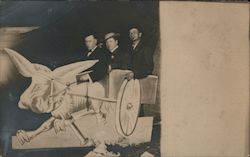 Three Men Posing with a Cut Out of a Cart and Donkey Postcard Postcard Postcard