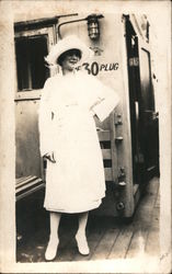 Photography of well dressed, all in white, young woman. Postcard