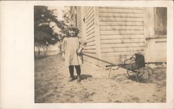 Little Girl in Dress Pulling Wagon Postcard