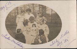 Pretty Smiling Girls Gathered Around to see Dolls Postcard