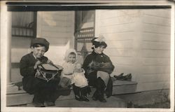 Three Children Sitting on a Porch with Toys, Drum, Doll Postcard Postcard Postcard