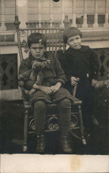 Young Boy in Rocking Chair and Young Girl Standing Postcard