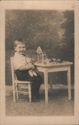 Little Boy with Stuffed Animal Sitting at a Table Postcard