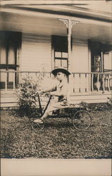 Cute Youngster with Hat Sitting on a type of Cycle Postcard