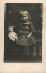 Little girl sitting in a chair. Postcard