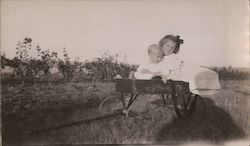 Two Precious Children Sitting in Wagon Postcard Postcard Postcard