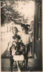 Three girls and a puppy. Postcard