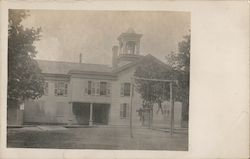 An old school house with two boys playing on a homemade wooden swing set. Postcard Postcard Postcard