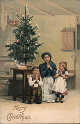 Mother and Children Praying in Front of Decorated Tree Postcard