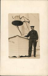 uniformed man standing next to a large bell Postcard