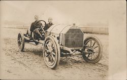 2 Men Driving a Car on a Dirt Road Postcard