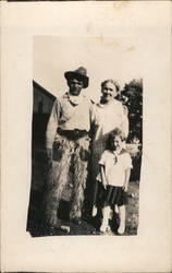 Man Wearing Wooly Chaps with Woman and Child Men Postcard Postcard Postcard