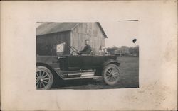 Man and 2 Children in a Car with a in Front of a Small Building Postcard