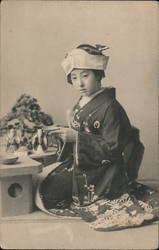 Young Japanese Woman drinking tea with typical dress Postcard