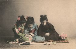 Japanese young girls reading a book Postcard