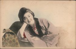 Smiling Geisha Reclinging on a Couch Postcard