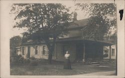 Woman in front of House Postcard