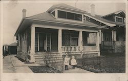 Two Children Standing In Front of Bungalow Style House Postcard