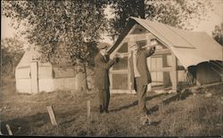 Two Guys Emptying Bottles in front of Service Camp Tents Postcard