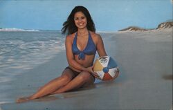 Woman on a beach with a beachball Postcard