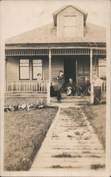 Family Sitting on Porch of House Postcard