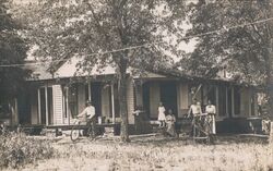 Family Posing on Porch with Bicycle and Wheelbarrow Postcard