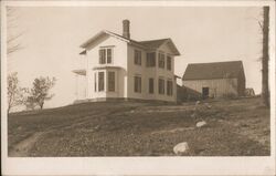 White Farmhouse and Barn on a Hill Postcard