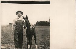 Man in Overalls and Hat with Foal Postcard