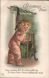 Christmas Time, Little Boy by Fireplace with Stocking Postcard