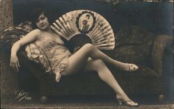 Leo 106, Woman Reclining on Chaise Lounge with Fan Postcard