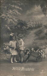 Two Children with Wheelbarrow and Flowers, Herzliche Frühlingsgrüße Postcard