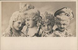 Four Young Girls in Fancy Dress and Wigs Postcard