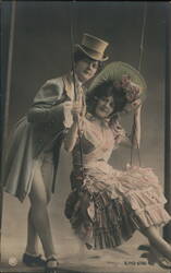 Couple in Theatrical Costumes on a Swing Postcard