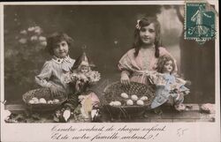 Two Children with Baskets of Eggs and Dolls, April Fool's Postcard