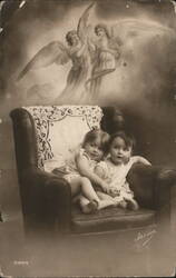 Two Children in Armchair with Angels Postcard