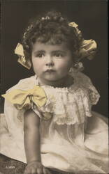 Baby Girl in White Dress with Yellow Bows Postcard