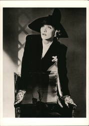 Marlene Dietrich Leaning over a Chair Postcard