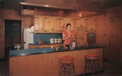 Wood-Metal Kitchen with Woman in Red Dress Postcard