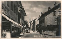 Le Sentier Street Scene with Shops and Church Steeple Postcard