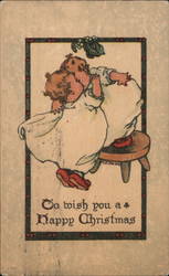 Two Children in Pajamas Kissing Under a Mistletoe Postcard Postcard Postcard