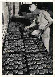 Man Brushing Glaze on Heart Cookies Postcard