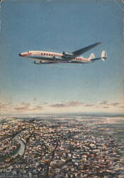 LAI Super Star Constellation Luxury Flight over City Postcard