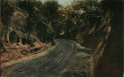 Dirt Road Through Cut in Rock Formation Postcard