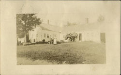 Couple with dog in front of home Postcard