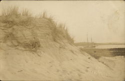 Sand dune with boat in background Postcard