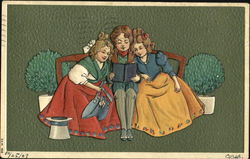 A boy sitting between two little girls reading Children Postcard Postcard